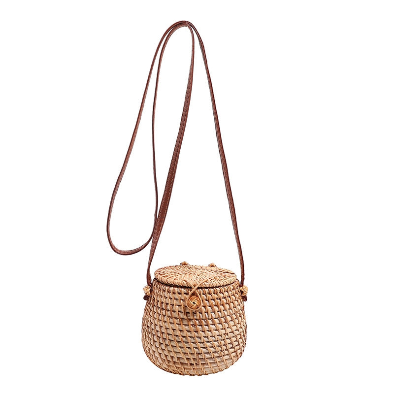 Handwoven eco-friendly Rattan Barrel Bag with PU leather crossbody strap, compact and stylish boho-chic accessory for daily use and special occasions.