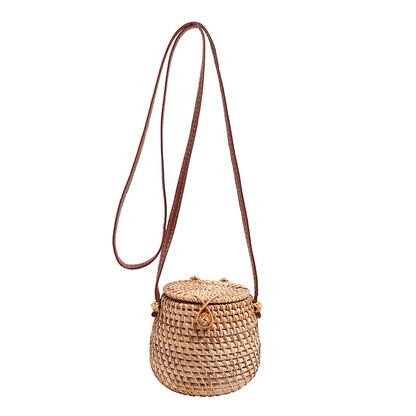 Handwoven eco-friendly Rattan Barrel Bag with PU leather crossbody strap, compact and stylish boho-chic accessory for daily use and special occasions.